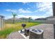 Well-kept backyard featuring a grill and decorative gravel, perfect for outdoor gatherings at 3078 Marine Grass Dr, Wimauma, FL 33598