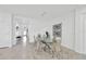 Modern dining room featuring a glass table, stylish chairs, and contemporary decor at 3078 Marine Grass Dr, Wimauma, FL 33598