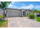 Beautiful home featuring a two-car garage and a brick paver driveway at 3078 Marine Grass Dr, Wimauma, FL 33598