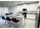 Bright kitchen featuring an island with bar seating, stainless appliances, and granite countertops at 3078 Marine Grass Dr, Wimauma, FL 33598