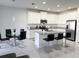Bright kitchen featuring granite counters, stainless steel appliances, and a breakfast bar at 3078 Marine Grass Dr, Wimauma, FL 33598