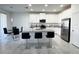 Bright and open kitchen featuring an island with bar stools, stainless steel appliances, and white cabinetry at 3078 Marine Grass Dr, Wimauma, FL 33598