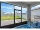 Enclosed lanai with view of the fenced backyard and landscaped yard, a serene outdoor retreat at 3078 Marine Grass Dr, Wimauma, FL 33598