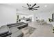 Spacious open concept living space featuring modern furnishings and connecting kitchen and dining areas at 3078 Marine Grass Dr, Wimauma, FL 33598
