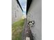 Narrow side yard featuring gravel landscaping and utilities for efficient use of space at 3078 Marine Grass Dr, Wimauma, FL 33598