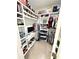 Organized walk-in closet featuring custom shelving, hanging rods, and a built-in desk area for added convenience at 3078 Marine Grass Dr, Wimauma, FL 33598