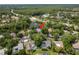 A captivating aerial view showing the home nestled among lush trees with a serene pond as its backdrop at 3138 Edgemoor Dr, Palm Harbor, FL 34685