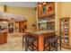 A well designed bar with a granite countertop, wine rack, and seating for 3-4 people at 3138 Edgemoor Dr, Palm Harbor, FL 34685