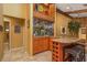 Stylish home bar area with granite countertop, custom cabinets, and wine rack, ideal for entertaining at 3138 Edgemoor Dr, Palm Harbor, FL 34685