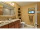 Well-lit bathroom with granite vanity, large mirror, decorative wall shelves, and a stylish shower at 3138 Edgemoor Dr, Palm Harbor, FL 34685