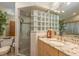 Modern bathroom with granite counters, a block glass shower, and stylish fixtures at 3138 Edgemoor Dr, Palm Harbor, FL 34685