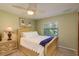 Bedroom featuring a comfortable bed, nightstand, window view, and soft lighting at 3138 Edgemoor Dr, Palm Harbor, FL 34685