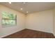 Bright bedroom with hardwood floors, a large window, neutral walls, and recessed lighting at 3138 Edgemoor Dr, Palm Harbor, FL 34685