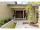 Inviting front entrance showcases double doors, tiled flooring, lovely plants and a decorative rock garden at 3138 Edgemoor Dr, Palm Harbor, FL 34685