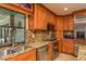 Modern kitchen featuring granite countertops, stainless steel appliances, and ample cabinet space at 3138 Edgemoor Dr, Palm Harbor, FL 34685