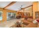 Bright living room with pool views, an open floor plan, and stylish wooden beam features at 3138 Edgemoor Dr, Palm Harbor, FL 34685