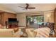 Relaxing living room featuring hardwood floors, a ceiling fan, and sliding glass doors to the outdoor pool at 3138 Edgemoor Dr, Palm Harbor, FL 34685