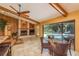 Living area with a fireplace and a large glass doors leading to a screened-in pool area at 3138 Edgemoor Dr, Palm Harbor, FL 34685