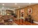 Open-concept living space with hardwood floors and mirrored walls, creating an expansive feel at 3138 Edgemoor Dr, Palm Harbor, FL 34685
