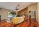 Spacious living room with hardwood floors, high ceilings, a ceiling fan, and a view of the outdoor pool at 3138 Edgemoor Dr, Palm Harbor, FL 34685