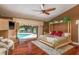 Tranquil main bedroom features a four-poster bed, hardwood floors, and private pool access at 3138 Edgemoor Dr, Palm Harbor, FL 34685