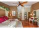Warm main bedroom with hardwood floors leads to ensuite bath and ample closet space at 3138 Edgemoor Dr, Palm Harbor, FL 34685