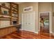 Home office area features built-in shelving, storage cabinets, granite countertop, and hardwood flooring at 3138 Edgemoor Dr, Palm Harbor, FL 34685