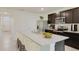 Bright kitchen showcasing stainless steel appliances, a large island with seating, and ample counter space at 32661 Osprey Peak Way, San Antonio, FL 33576