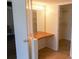 Bathroom with vanity and large mirror leading to closet with metal shelving at 3311 Teeside Dr, New Port Richey, FL 34655