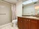Bright bathroom featuring shower with grab bar, new vanity, and patterned shower curtain at 3311 Teeside Dr, New Port Richey, FL 34655