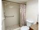 Bathroom featuring shower with grab bar, tiled flooring, and patterned shower curtain at 3311 Teeside Dr, New Port Richey, FL 34655