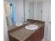 Bathroom vanity featuring granite countertops and sink with cabinets below at 3311 Teeside Dr, New Port Richey, FL 34655