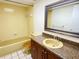 Bright bathroom with classic yellow tile, vanity, and a well-lit mirror at 3311 Teeside Dr, New Port Richey, FL 34655