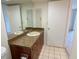 Bathroom featuring a single sink vanity, a decorative mirror, and a tiled floor at 3311 Teeside Dr, New Port Richey, FL 34655