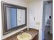 Bathroom featuring vanity with granite counters and decorative mirror at 3311 Teeside Dr, New Port Richey, FL 34655