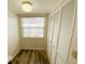 Cozy bedroom featuring light wood floors, a bright window, and closet at 3311 Teeside Dr, New Port Richey, FL 34655