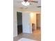 Spacious bedroom featuring tile floors, ceiling fan, and access to closet and bathroom at 3311 Teeside Dr, New Port Richey, FL 34655