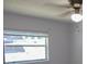 Bright bedroom featuring a ceiling fan and a large window at 3311 Teeside Dr, New Port Richey, FL 34655