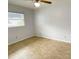Neutral bedroom with tile floors, ceiling fan, and window offering plenty of light at 3311 Teeside Dr, New Port Richey, FL 34655