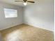 This bedroom has a window allowing ample light, and tile flooring at 3311 Teeside Dr, New Port Richey, FL 34655
