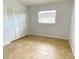 Cozy bedroom with tile flooring, double door closet, and a window providing natural light at 3311 Teeside Dr, New Port Richey, FL 34655