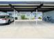 Carport parking with light blue exterior and lush landscaping, bike and view of apartment at 3311 Teeside Dr, New Port Richey, FL 34655