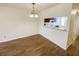 Open dining area with wood-look floors and a view into the adjacent kitchen at 3311 Teeside Dr, New Port Richey, FL 34655
