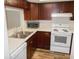 Well-lit kitchen equipped with stainless steel sink, microwave and modern appliances at 3311 Teeside Dr, New Port Richey, FL 34655
