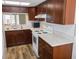 Updated kitchen featuring white appliances, wooden cabinets, and modern countertops at 3311 Teeside Dr, New Port Richey, FL 34655