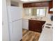 Efficient kitchen with wooden cabinets, white appliances, and durable countertops at 3311 Teeside Dr, New Port Richey, FL 34655