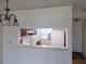 View through the kitchen pass-through, equipped with appliances and ample space at 3311 Teeside Dr, New Port Richey, FL 34655