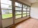 Enclosed lanai with tile flooring, screens, and views of the surrounding landscape at 3311 Teeside Dr, New Port Richey, FL 34655
