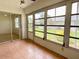 Enclosed lanai with tile flooring, screens, and views of the surrounding landscape at 3311 Teeside Dr, New Port Richey, FL 34655