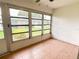 Enclosed lanai with tile flooring, screens, and views of the surrounding landscape at 3311 Teeside Dr, New Port Richey, FL 34655